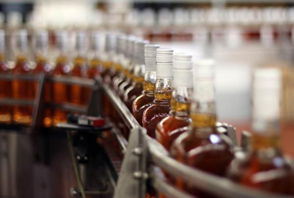 Bottles of distilled spirits on bottling line.