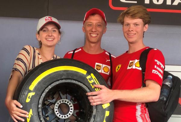 澳门足彩app intern Emily Moseley holding a racing tire.